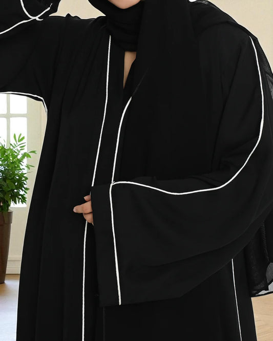 Black Front-Open Abaya in Firdaus Fabric with White Piping, Side Pockets & Snap Buttons