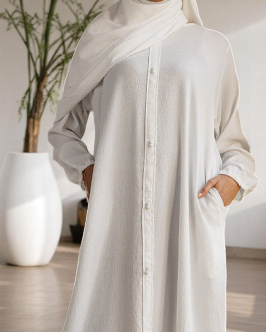 A-Line Closed White Abaya in CYE Crush Fabric with Show Buttons, Wide Sleeves, Pockets & V-Neck